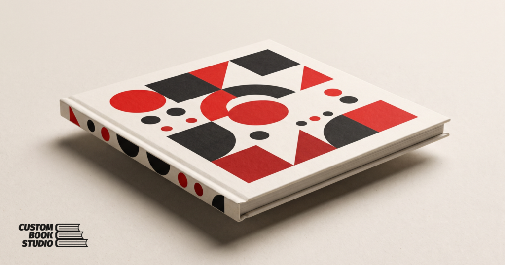 Custom Book Studio — a super-slim children's hardcover picture book with sharp square corners and bold red and ink geometric shapes (watermarked).